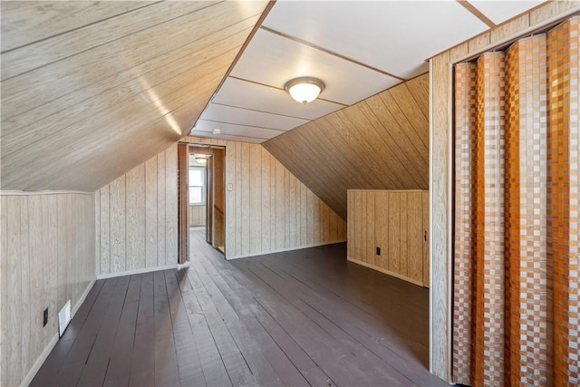 413 Pasadena Dr, Port Vue, PA 15133 - additional living space with visible vents, wood walls, baseboards, dark wood-type flooring, and vaulted ceiling