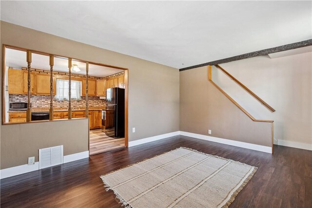 413 Pasadena Dr, Port Vue, PA 15133 - unfurnished living room featuring visible vents, stairs, dark wood finished floors, and baseboards