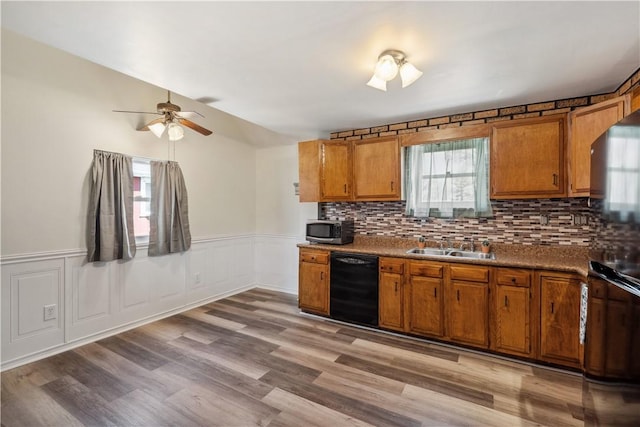 413 Pasadena Dr, Port Vue, PA 15133 - kitchen with black dishwasher, brown cabinets, stainless steel microwave, and a ceiling fan