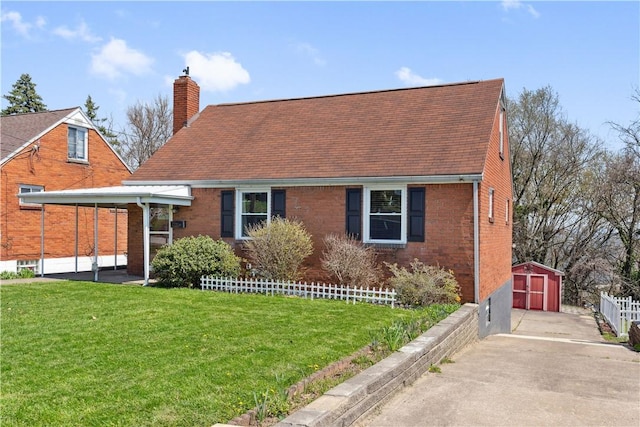 413 Pasadena Dr, Port Vue, PA 15133 - view of front of house with a front lawn, brick siding, an outbuilding, a chimney, and concrete driveway