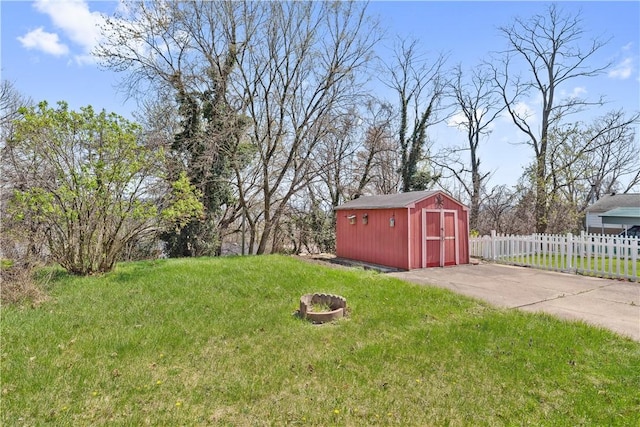 413 Pasadena Dr, Port Vue, PA 15133 - view of yard featuring an outdoor structure, fence, a shed, and an outdoor fire pit