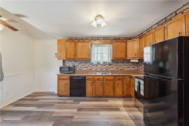 413 Pasadena Dr, Port Vue, PA 15133 - kitchen featuring brown cabinets, ceiling fan, a sink, light wood-type flooring, and black appliances