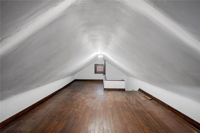 bonus room with baseboards, wood-type flooring, and lofted ceiling