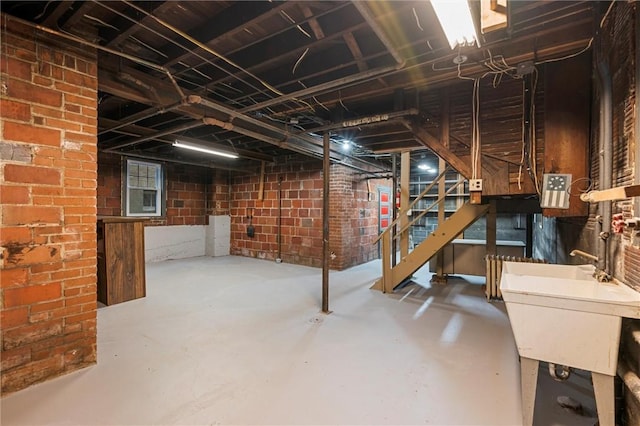 unfinished below grade area featuring a sink and stairway