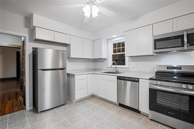 kitchen featuring light countertops, a ceiling fan, stainless steel appliances, and a sink