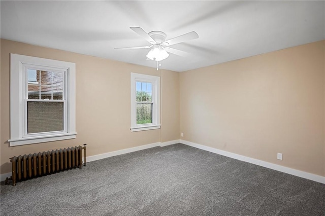 unfurnished room featuring carpet floors, a ceiling fan, baseboards, and radiator