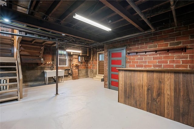 unfinished basement featuring a sink and stairway