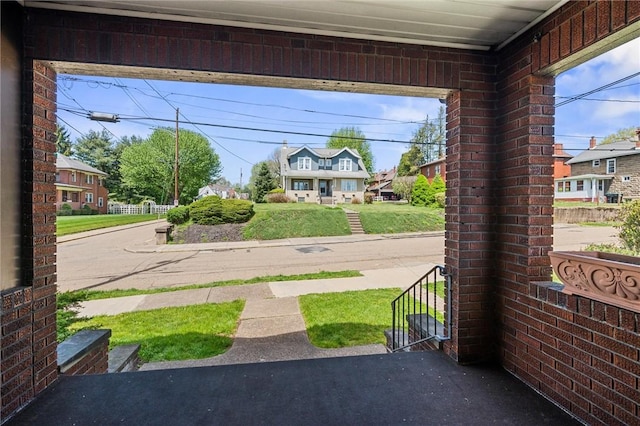 entryway with brick wall and a residential view