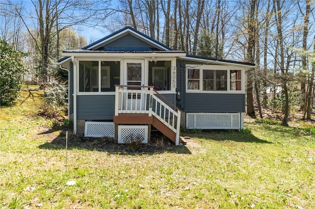 bungalow featuring a front yard and a sunroom