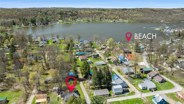 aerial view with a water view, a view of trees, and a residential view