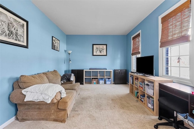 carpeted living room with baseboards