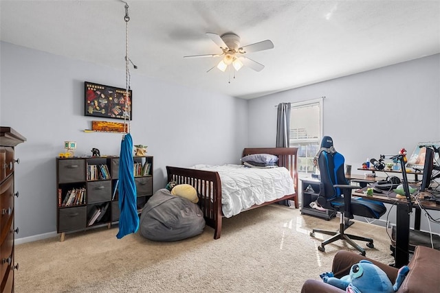 carpeted bedroom featuring baseboards and ceiling fan
