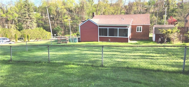 419 Streets Run Rd, Whitehall, PA 15236 - back of property with a fenced backyard, a storage unit, a sunroom, a lawn, and an outbuilding