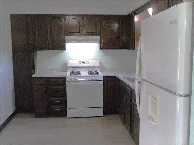 419 Streets Run Rd, Whitehall, PA 15236 - kitchen with dark brown cabinets, light countertops, light wood finished floors, under cabinet range hood, and white appliances