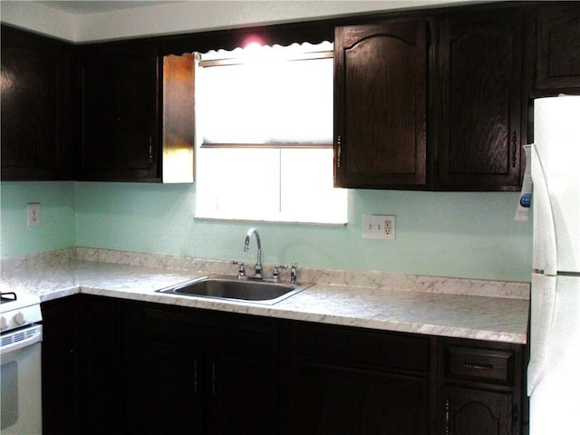 419 Streets Run Rd, Whitehall, PA 15236 - kitchen featuring white appliances, dark brown cabinets, a sink, and light countertops