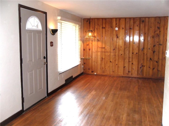 419 Streets Run Rd, Whitehall, PA 15236 - foyer entrance with baseboards, wood walls, and wood finished floors