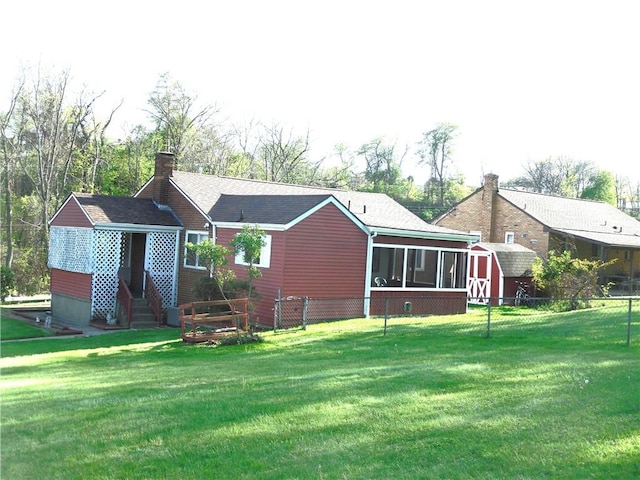 419 Streets Run Rd, Whitehall, PA 15236 - back of house featuring fence, a storage shed, a sunroom, a chimney, and an outdoor structure