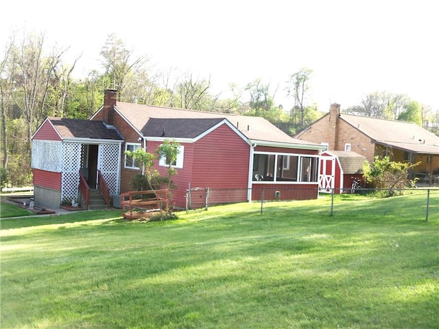 419 Streets Run Rd, Whitehall, PA 15236 - back of house with a chimney, a lawn, an outbuilding, a sunroom, and a shed