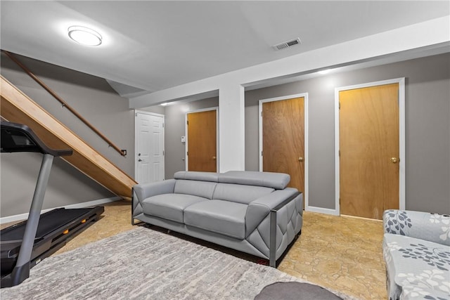 living room with baseboards, stairs, and visible vents
