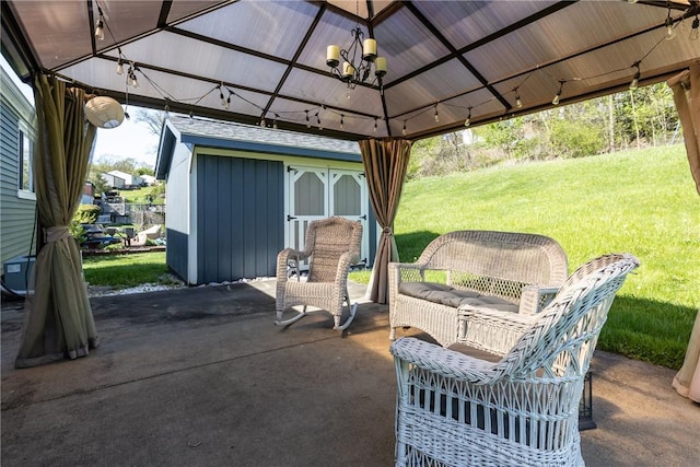 view of patio featuring a gazebo and an outbuilding