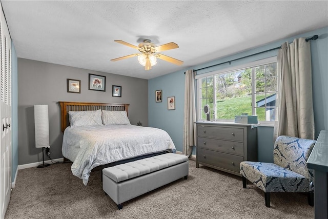 carpeted bedroom with baseboards and a ceiling fan