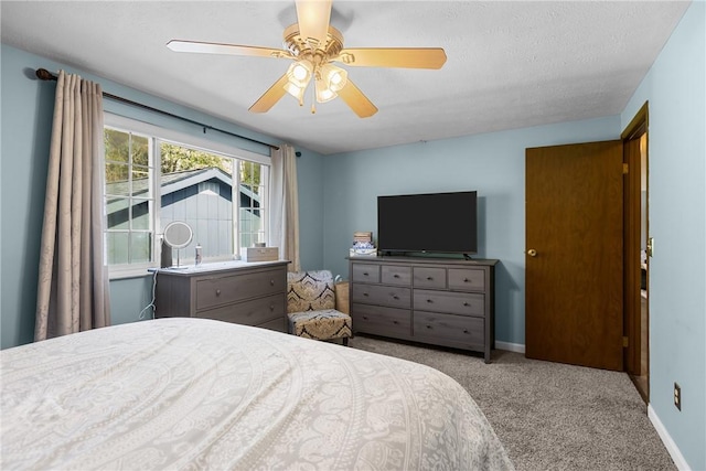 carpeted bedroom with baseboards and ceiling fan