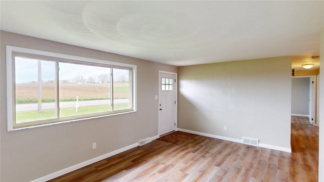 entryway featuring baseboards, visible vents, and light wood-style flooring
