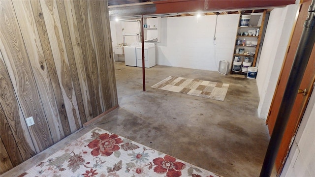 unfinished basement featuring a sink and washer and clothes dryer