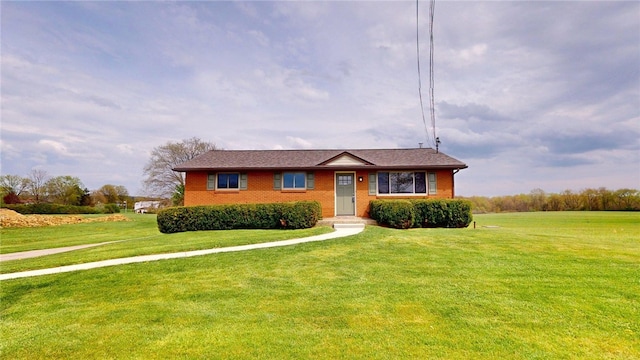 view of front facade featuring a front lawn and brick siding