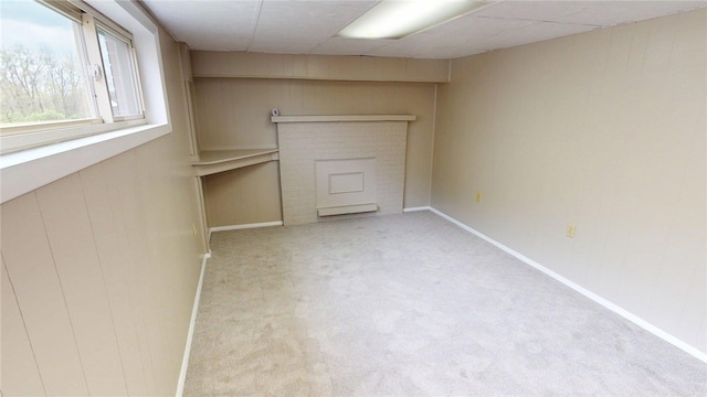 interior space with baseboards, carpet flooring, and a fireplace