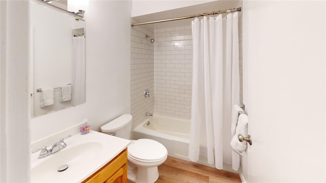 full bath with vanity, wood finished floors, shower / bath combo, and toilet
