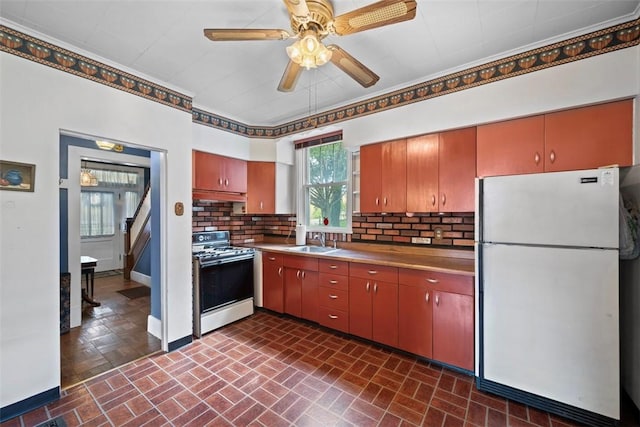 508 Cascade, Forest Hills Boro, PA 15221 - kitchen featuring range with gas cooktop, tasteful backsplash, a sink, freestanding refrigerator, and brick patterned floor