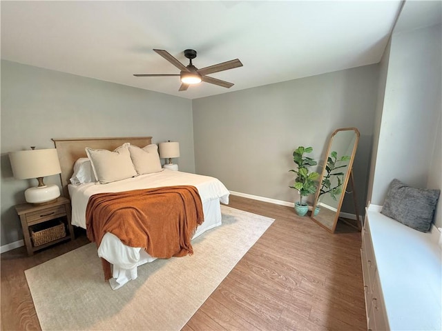 bedroom featuring baseboards, a ceiling fan, and wood finished floors