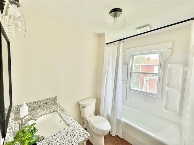 bathroom featuring vanity, toilet, wood finished floors, and shower / tub combo with curtain