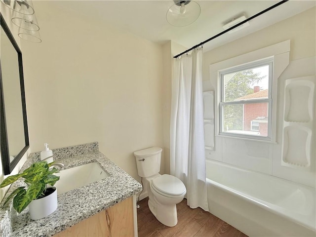 full bathroom featuring vanity, wood finished floors, toilet, and shower / bath combo with shower curtain