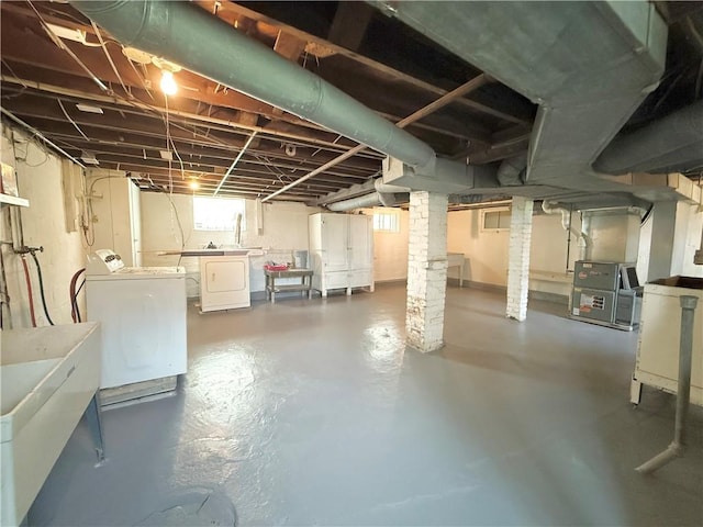 below grade area featuring washer and dryer and a sink