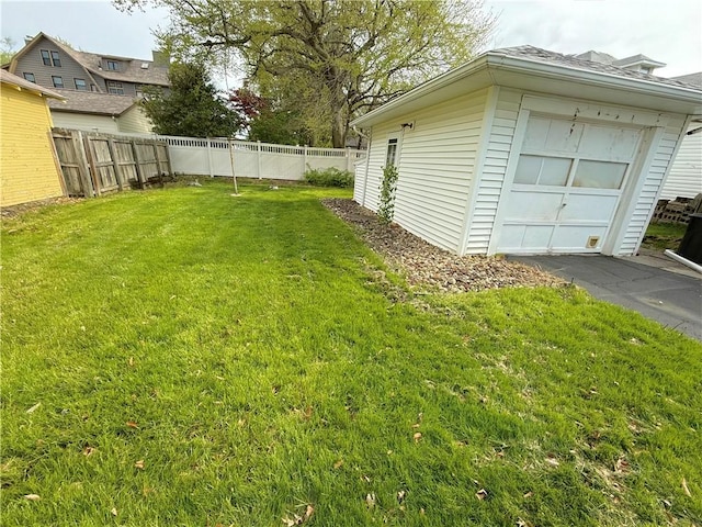 view of yard with a fenced backyard and a garage