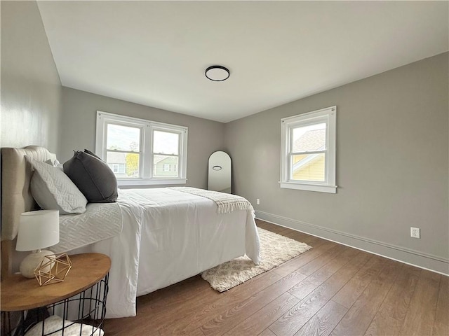 bedroom featuring baseboards and wood-type flooring