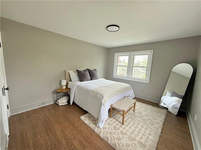 bedroom featuring baseboards and wood finished floors