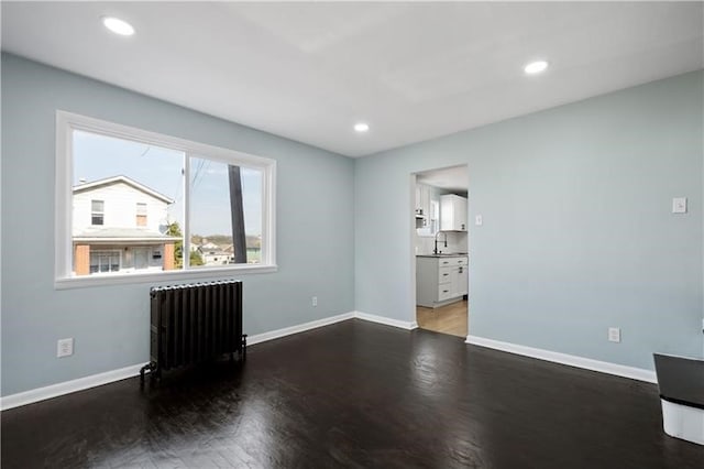 901 Union Ave, Mckeesport, PA 15132 - spare room featuring radiator heating unit, baseboards, and wood finished floors