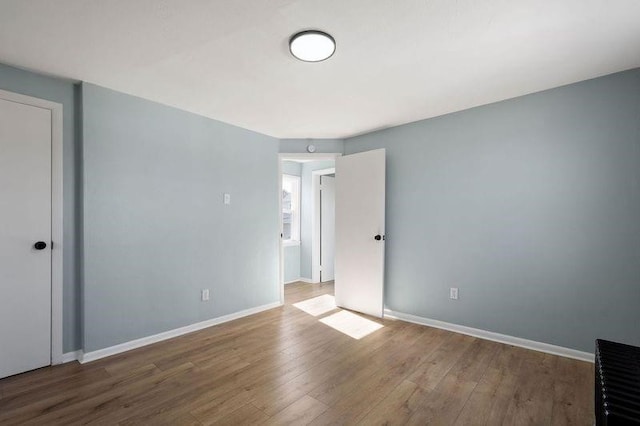 901 Union Ave, Mckeesport, PA 15132 - unfurnished bedroom with baseboards and wood finished floors