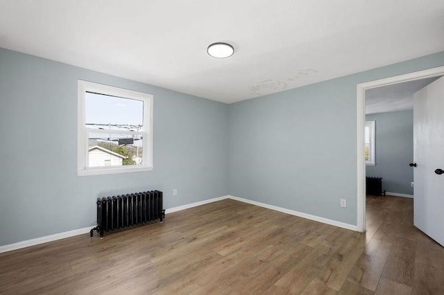 901 Union Ave, Mckeesport, PA 15132 - spare room with plenty of natural light, baseboards, radiator heating unit, and wood finished floors