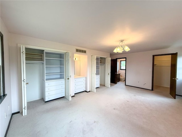 1194 Butler Rd, East Franklin Twp, PA 16262 - unfurnished bedroom featuring a chandelier, light colored carpet, two closets, and baseboards