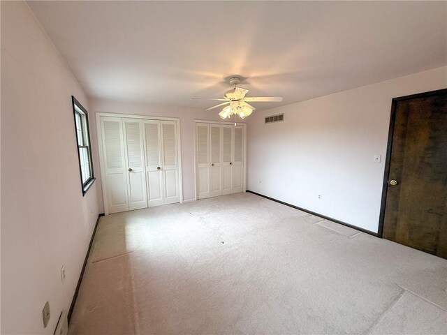 1194 Butler Rd, East Franklin Twp, PA 16262 - unfurnished bedroom featuring multiple closets, light carpet, ceiling fan, and baseboards