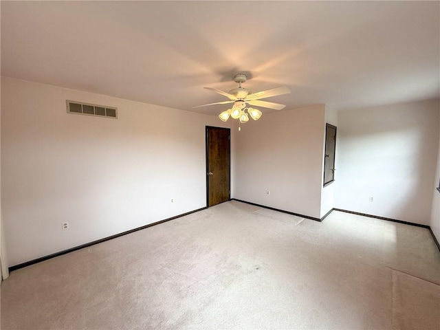 unfurnished room featuring a ceiling fan, light colored carpet, visible vents, and baseboards