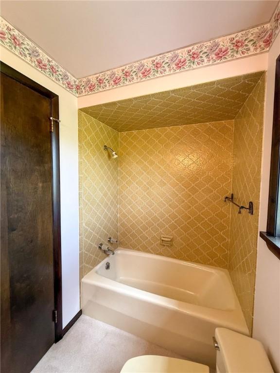 full bath featuring bathing tub / shower combination and toilet