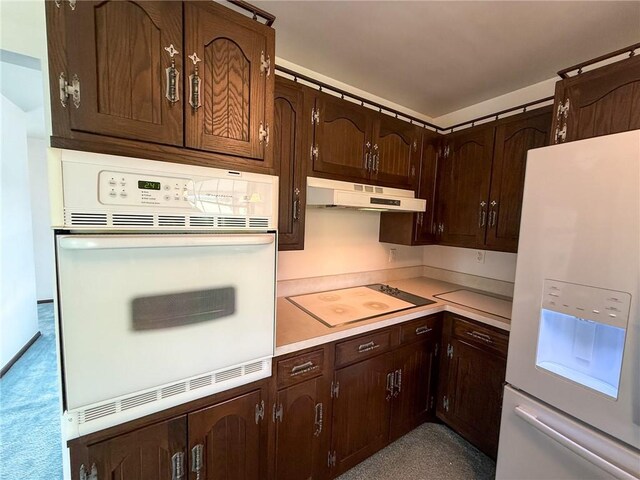 1194 Butler Rd, East Franklin Twp, PA 16262 - kitchen featuring white appliances, under cabinet range hood, light countertops, and dark brown cabinetry