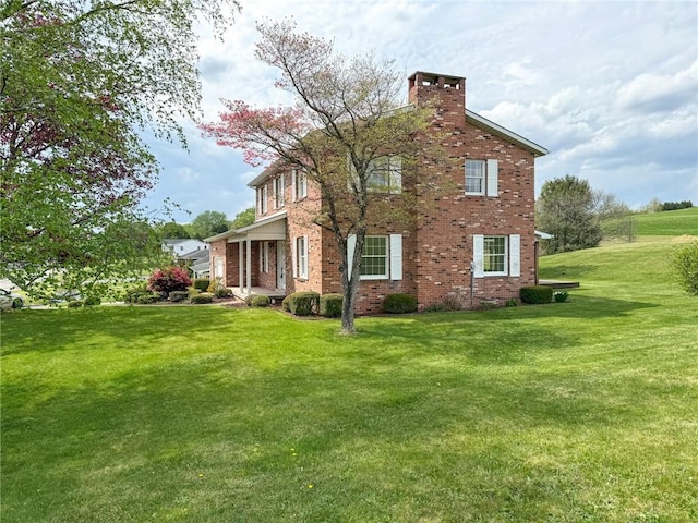 1194 Butler Rd, East Franklin Twp, PA 16262 - view of property exterior with brick siding, a chimney, and a yard