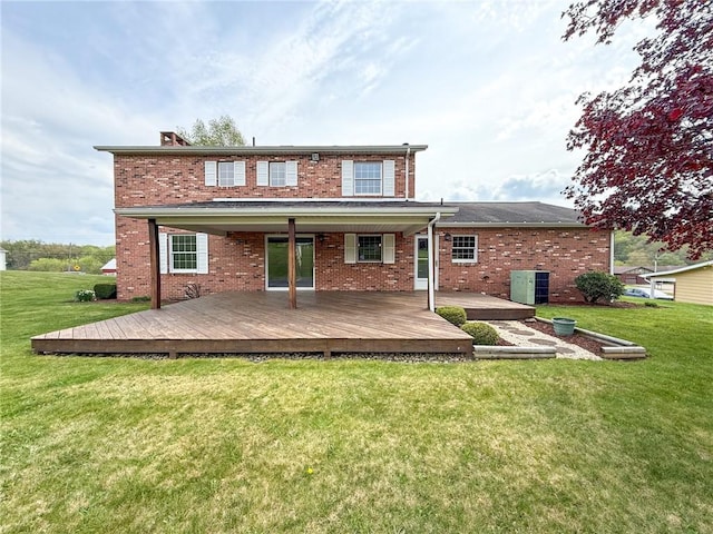 back of property with brick siding, central AC unit, a yard, and a deck