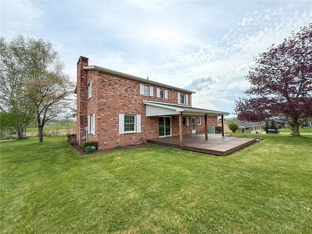 1194 Butler Rd, East Franklin Twp, PA 16262 - rear view of property with a chimney, brick siding, a yard, and a wooden deck